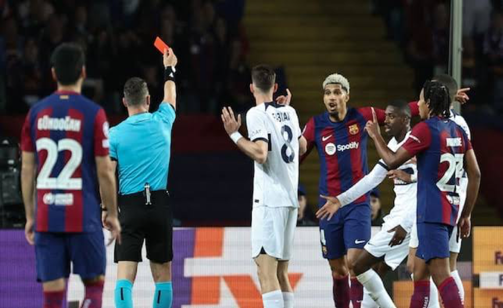 Referee showing red card in a match during Real Madrid vs Barcelona